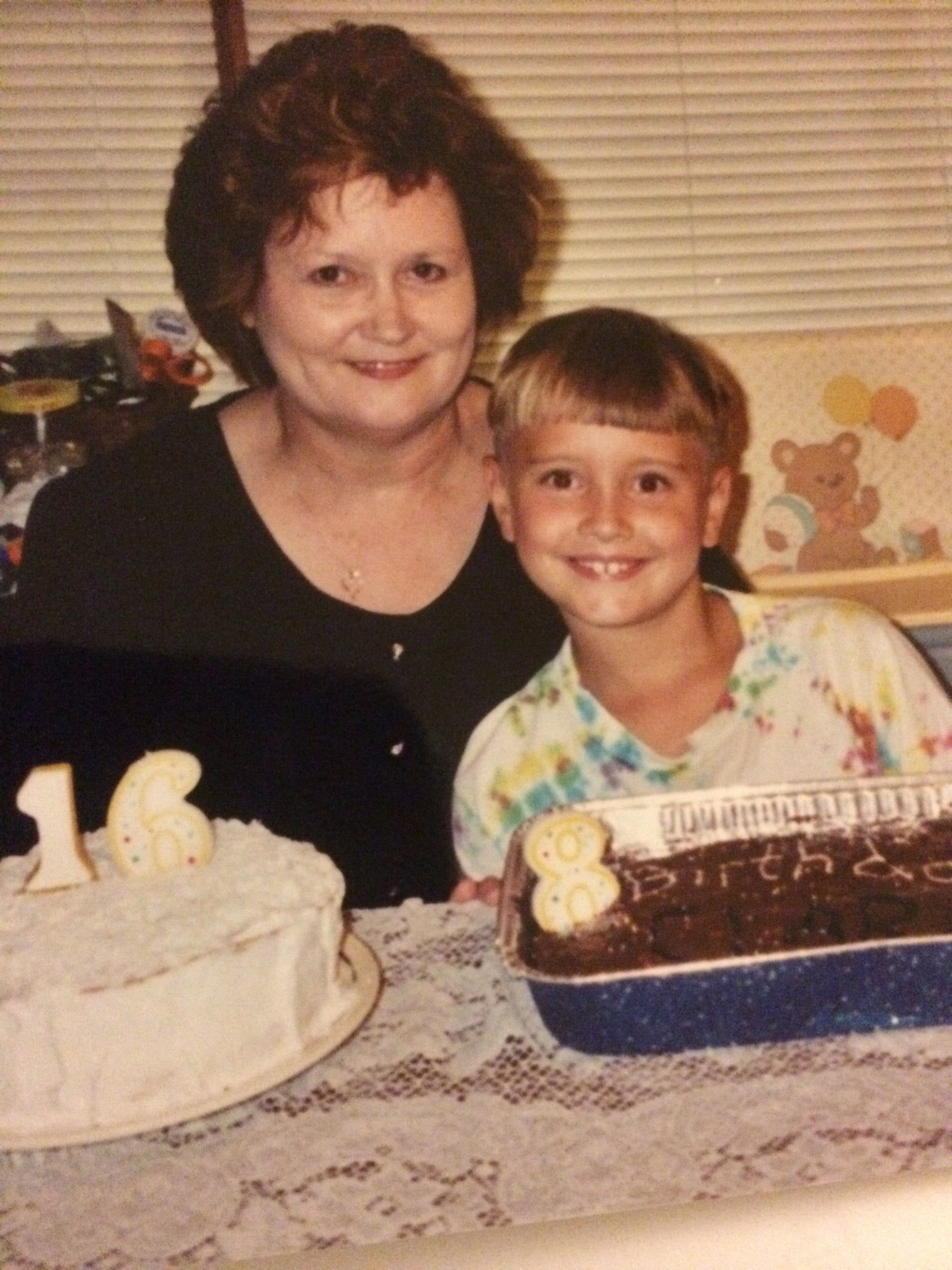 Woman and child with birthday cakes in a home setting